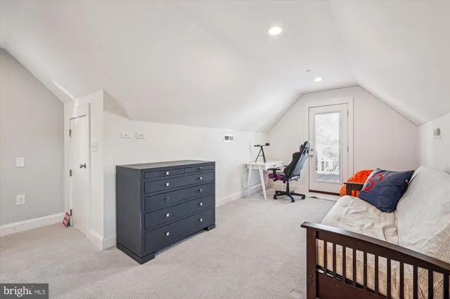 a bedroom with a bed and a dresser in it