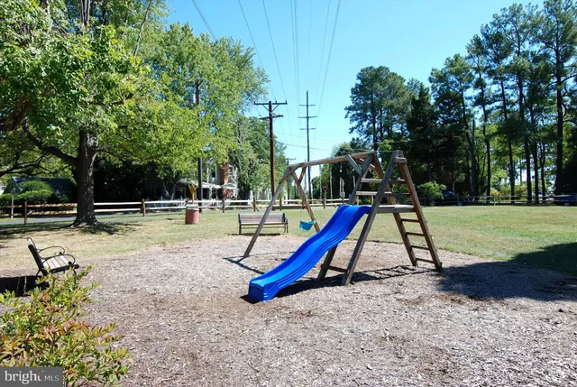 a swimming pool with lots of tress in front of it
