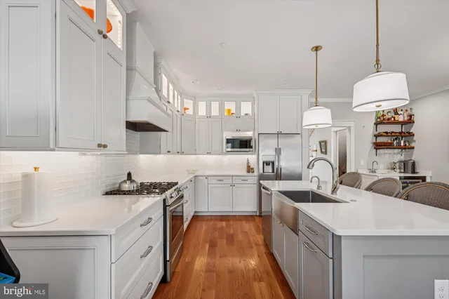 a kitchen with a sink a stove and chairs
