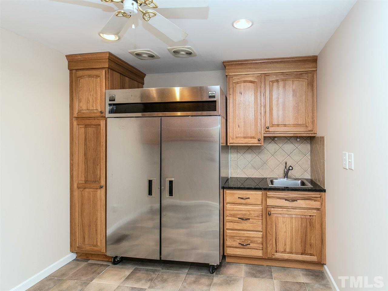 2524 Win Road Garner, NC 27529 - Photo 14 of 25 Large laundry room off the kitchen. Storage cabinets above the washer/dryer area. Storage cabinets on both sides of fridge.
