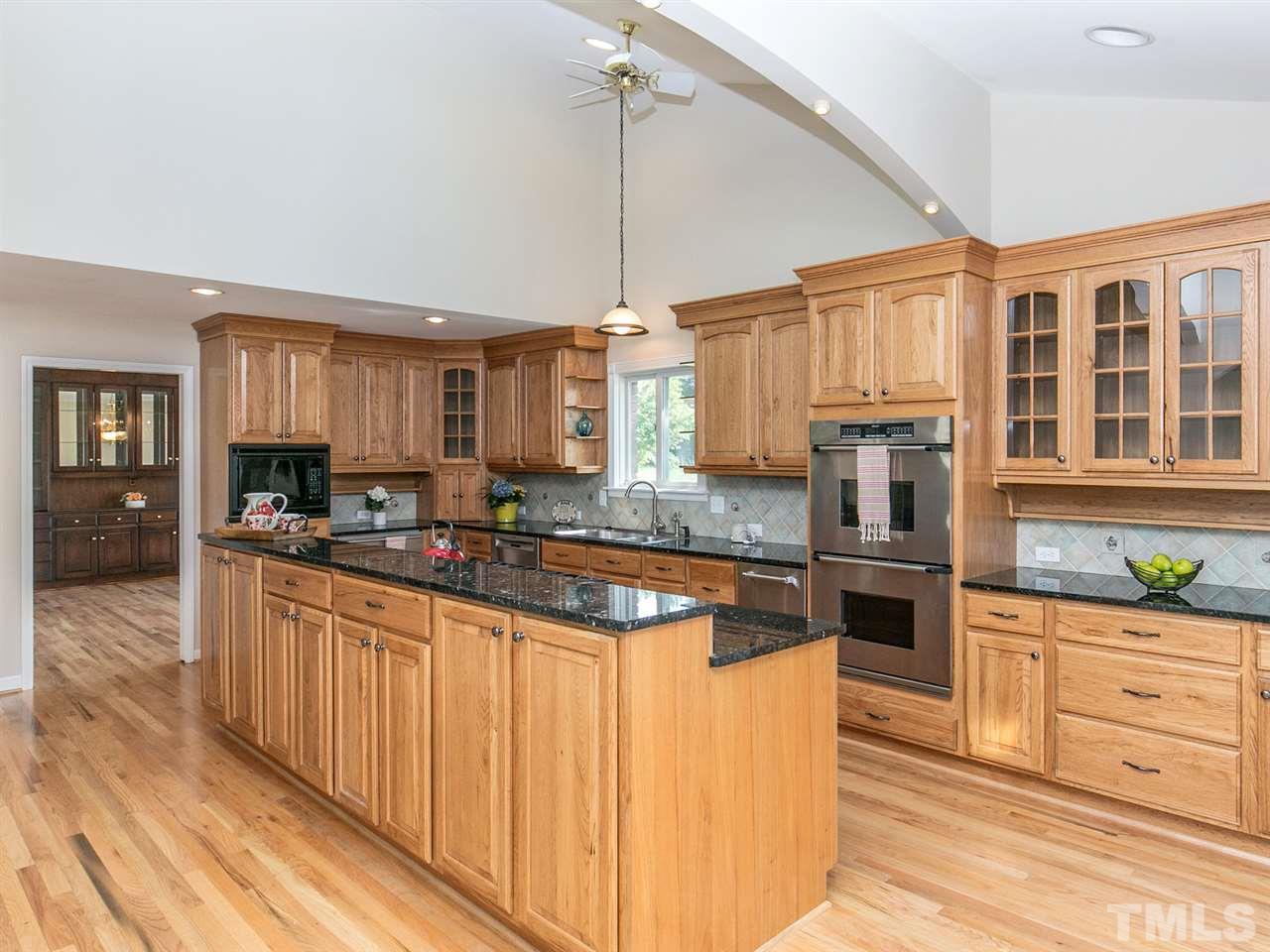 2524 Win Road Garner, NC 27529 - Photo 5 of 25 Beautiful cabinets with pull-outs & ample shelving. Double Dacor Ovens. New Bosch dishwasher. New KitchenAid ice maker. Double refrigerator drawers in kitchen. Refinished hardwoods. Granite & tile backsplash. Large pantry.