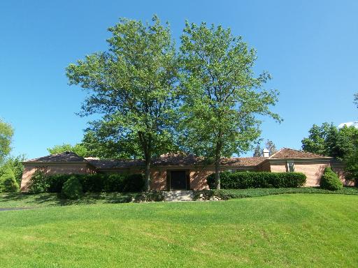 47 Little Cahill Road Cary, IL 60013 - Photo 1 of 1 a view of a patio with a table and chairs under an umbrella