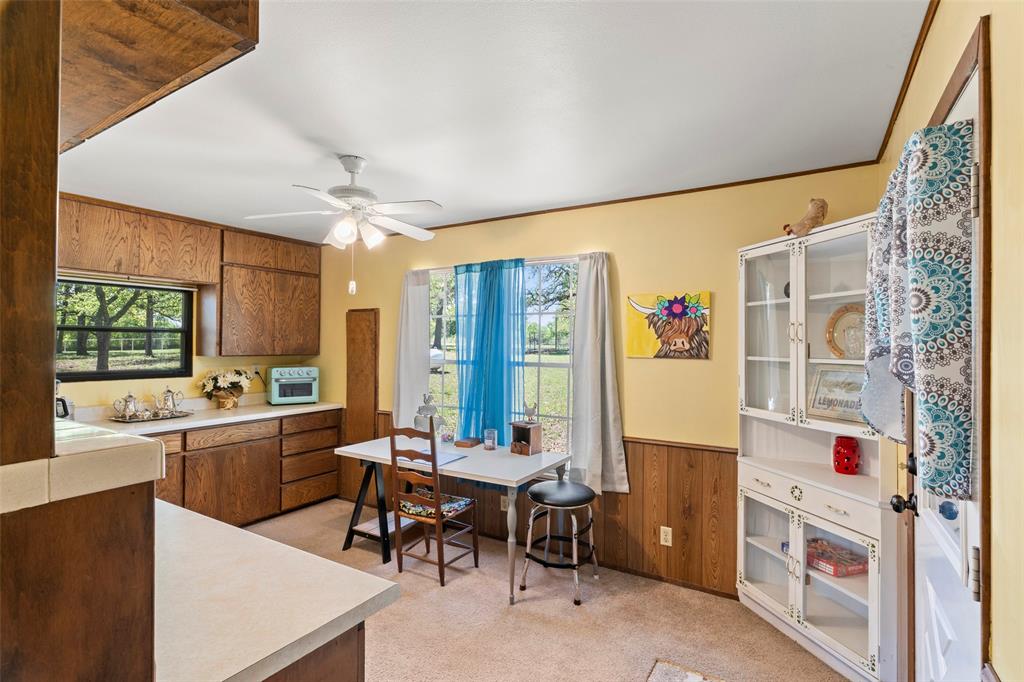 1500 County Road 404 Comanche, TX 76442 - Photo 13 of 39 a kitchen with stainless steel appliances kitchen island granite countertop a refrigerator and a sink