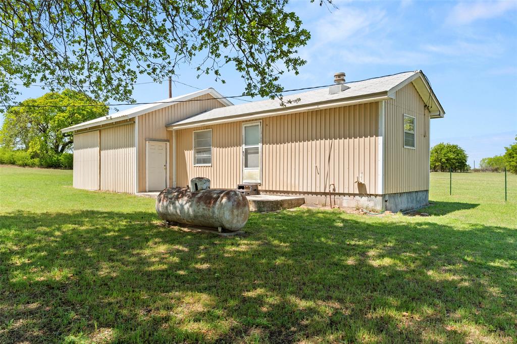 1500 County Road 404 Comanche, TX 76442 - Photo 26 of 39 a backyard of a house with table and chairs