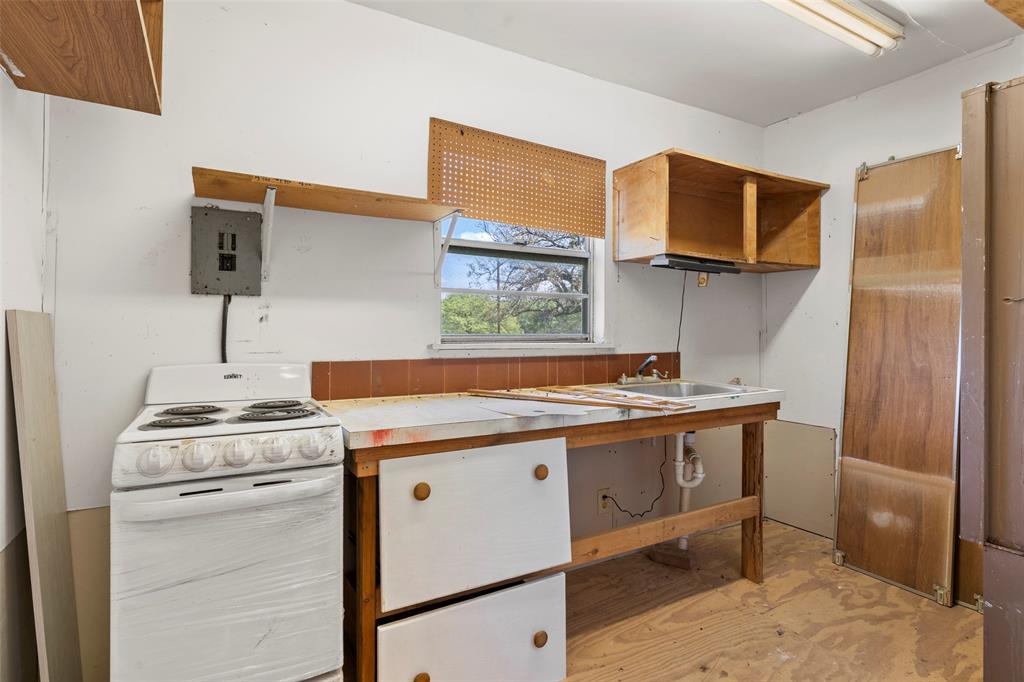 1500 County Road 404 Comanche, TX 76442 - Photo 28 of 39 a kitchen with a stove and a sink