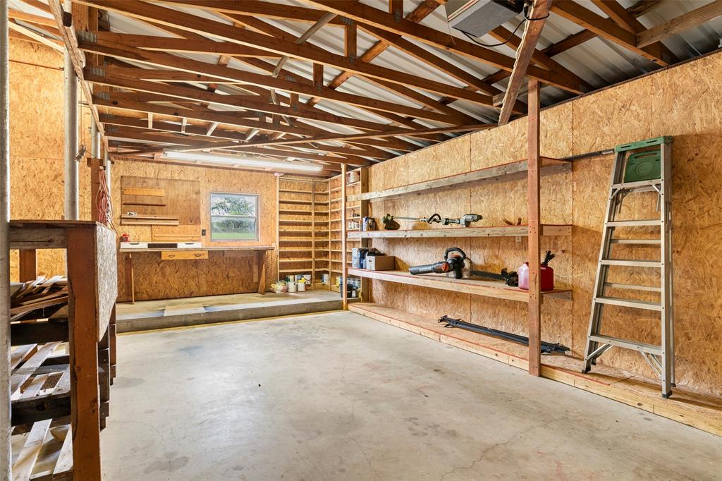 1500 County Road 404 Comanche, TX 76442 - Photo 29 of 39 Garage featuring a workshop area and wood walls