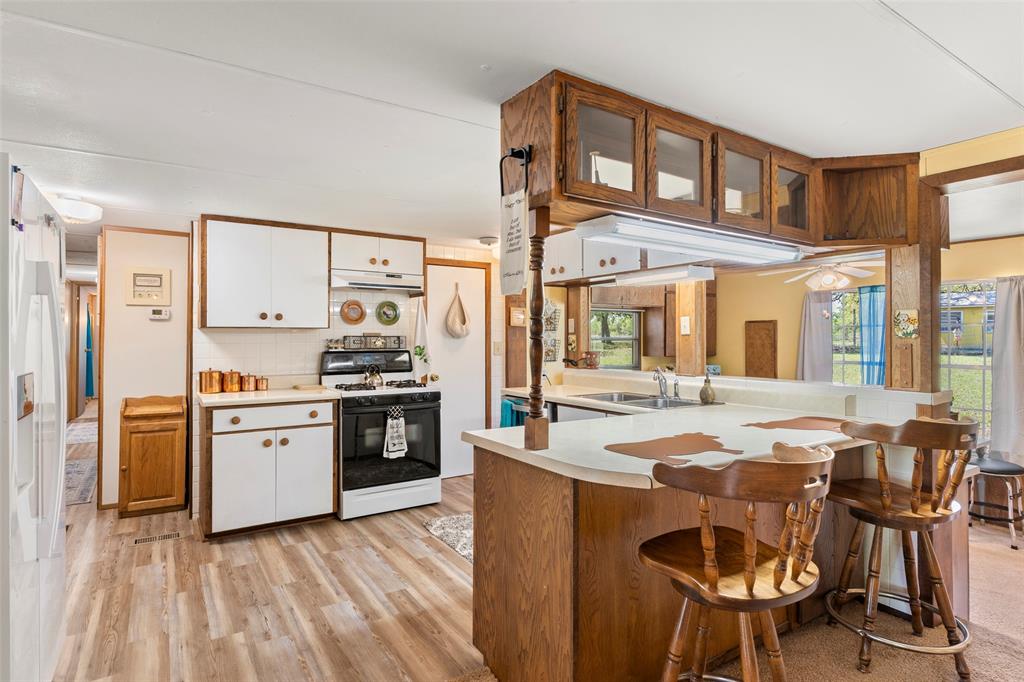 1500 County Road 404 Comanche, TX 76442 - Photo 3 of 39 a kitchen with stainless steel appliances granite countertop a stove and a refrigerator