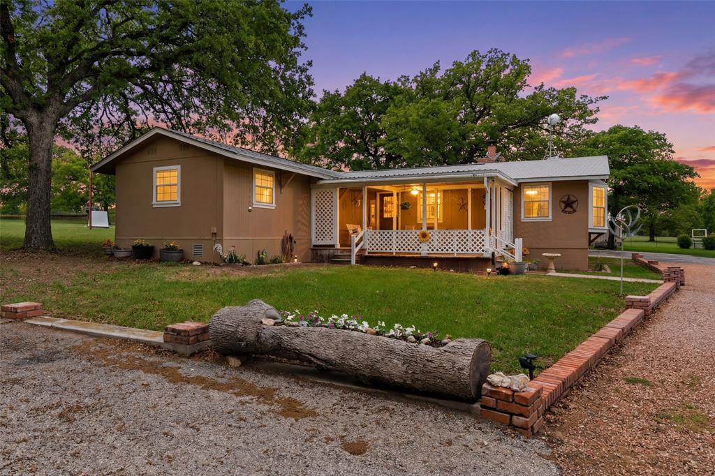 1500 County Road 404 Comanche, TX 76442 - Photo 36 of 39 a front view of a house with a garden and yard