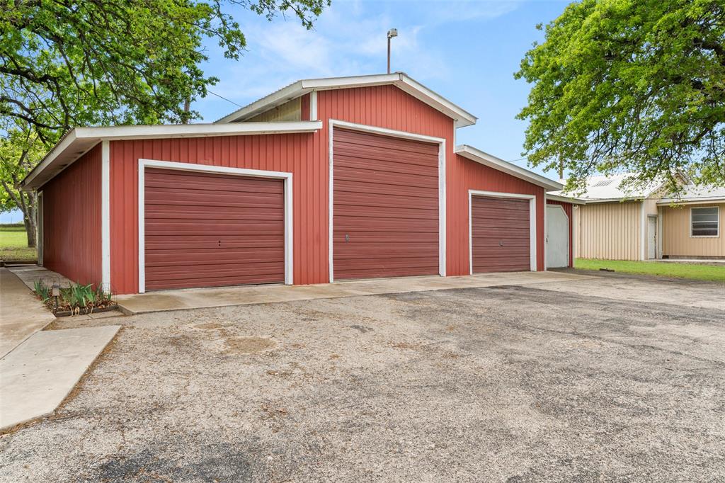 1500 County Road 404 Comanche, TX 76442 - Photo 4 of 39 a front view of a house with a yard and garage
