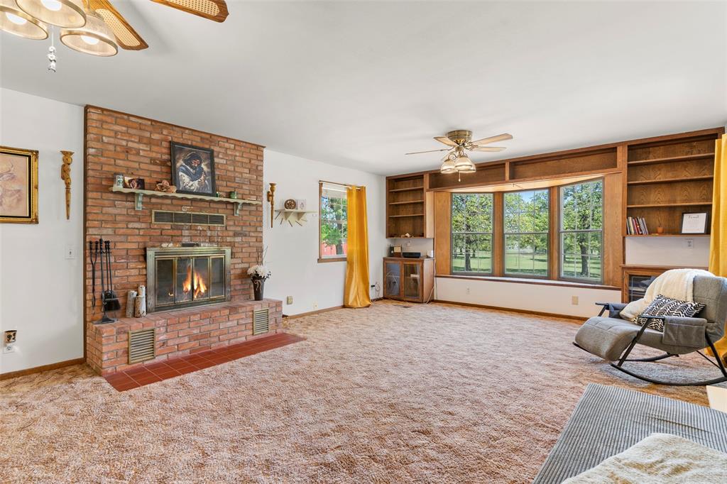 1500 County Road 404 Comanche, TX 76442 - Photo 9 of 39 a living room with furniture window and a fireplace
