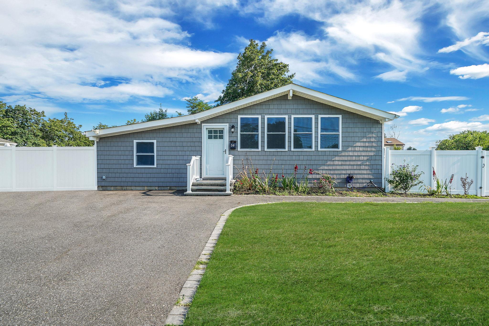 56 Hackmatac Street Central Islip, NY 11722 - Photo 1 of 1 a front view of a house with a garden