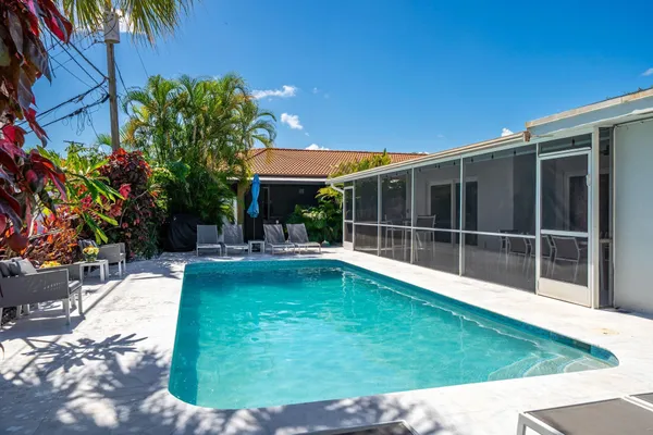 a swimming pool with outdoor seating and yard