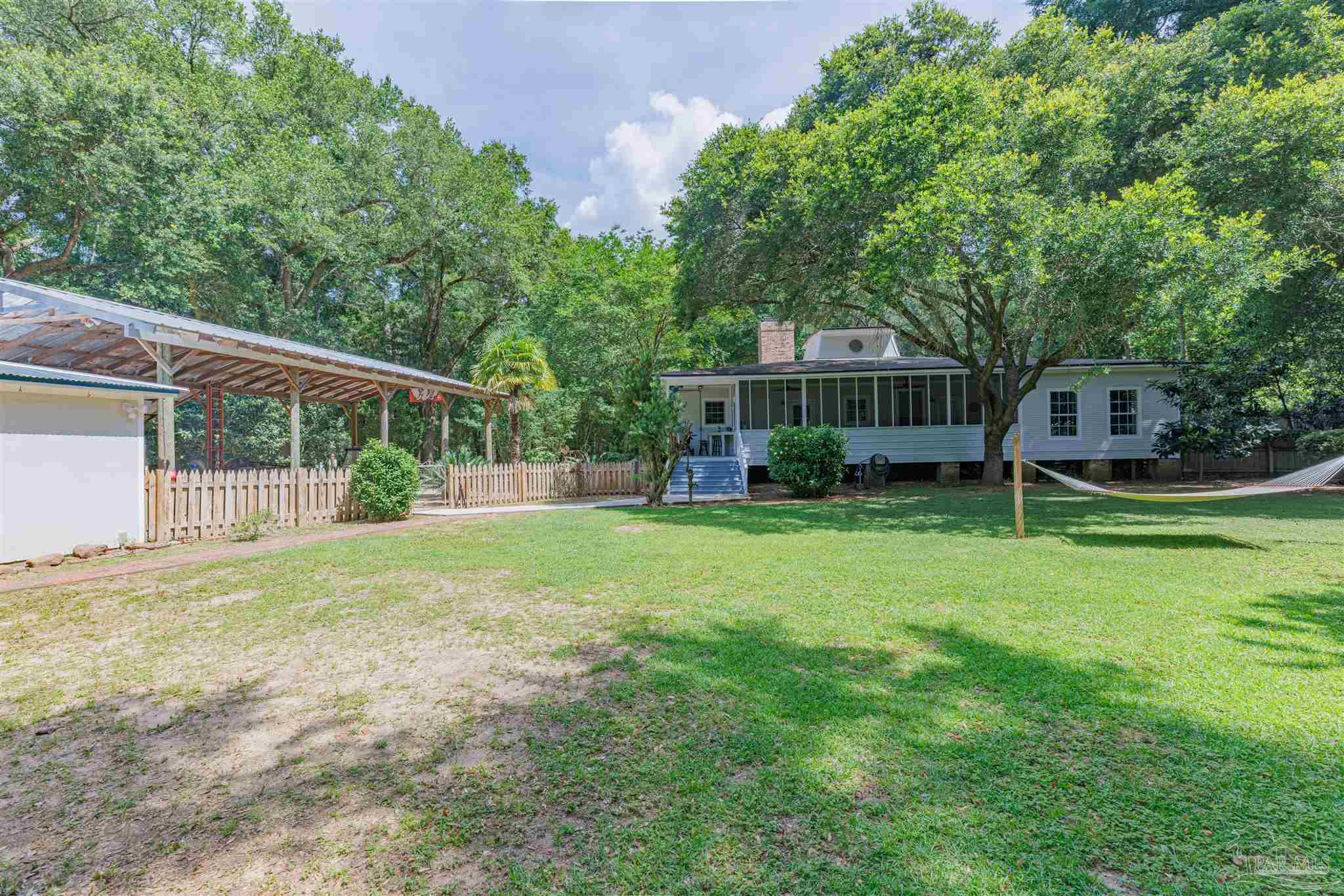 5049 Guernsey Road Pace, FL 32571 - Photo 58 of 61 a view of a house with backyard and sitting area