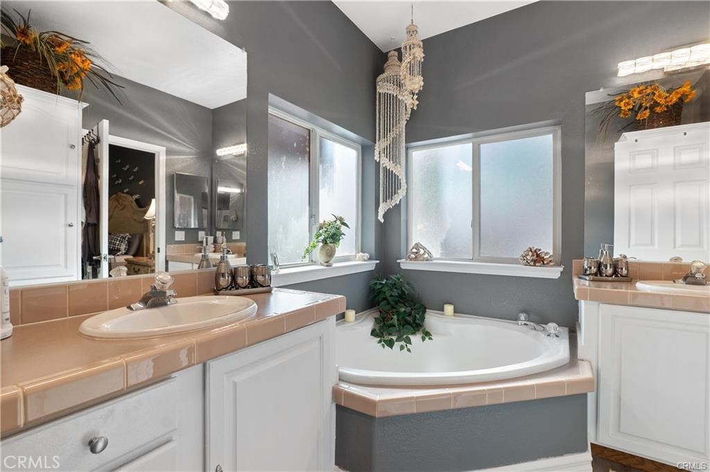 1188 Beach Drive Needles, CA 92363 - Photo 16 of 41 a bathroom with a sink a large mirror and a bathtub