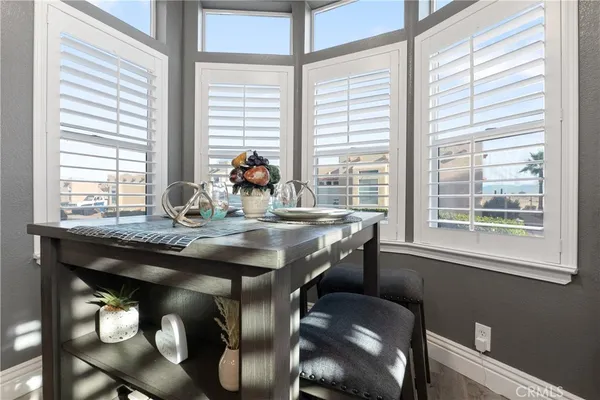 a dining table with chairs and window