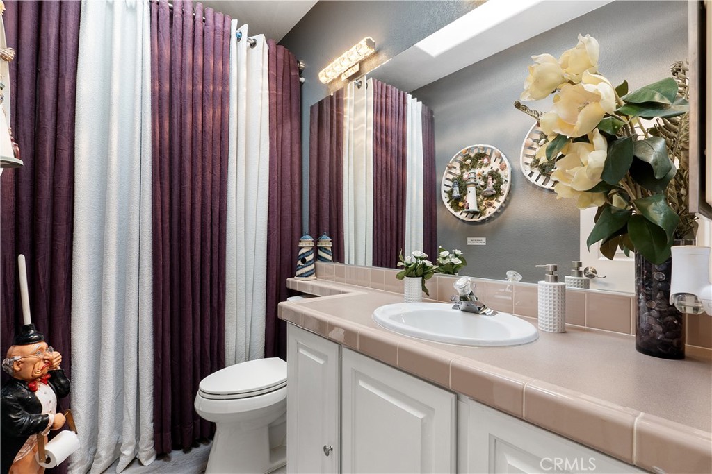 1188 Beach Drive Needles, CA 92363 - Photo 19 of 41 a bathroom with a sink a toilet and a mirror