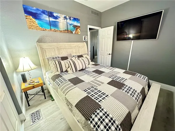 a bedroom with a bed and a flat screen tv