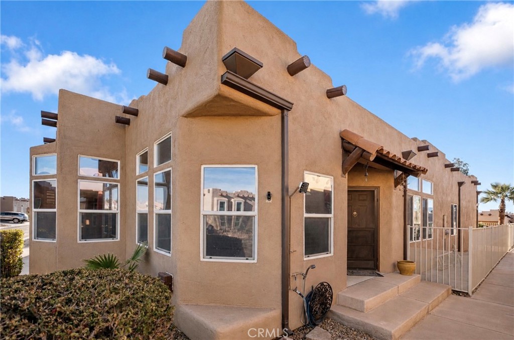 1188 Beach Drive Needles, CA 92363 - Photo 3 of 41 a front view of a house with a lots of windows and plants