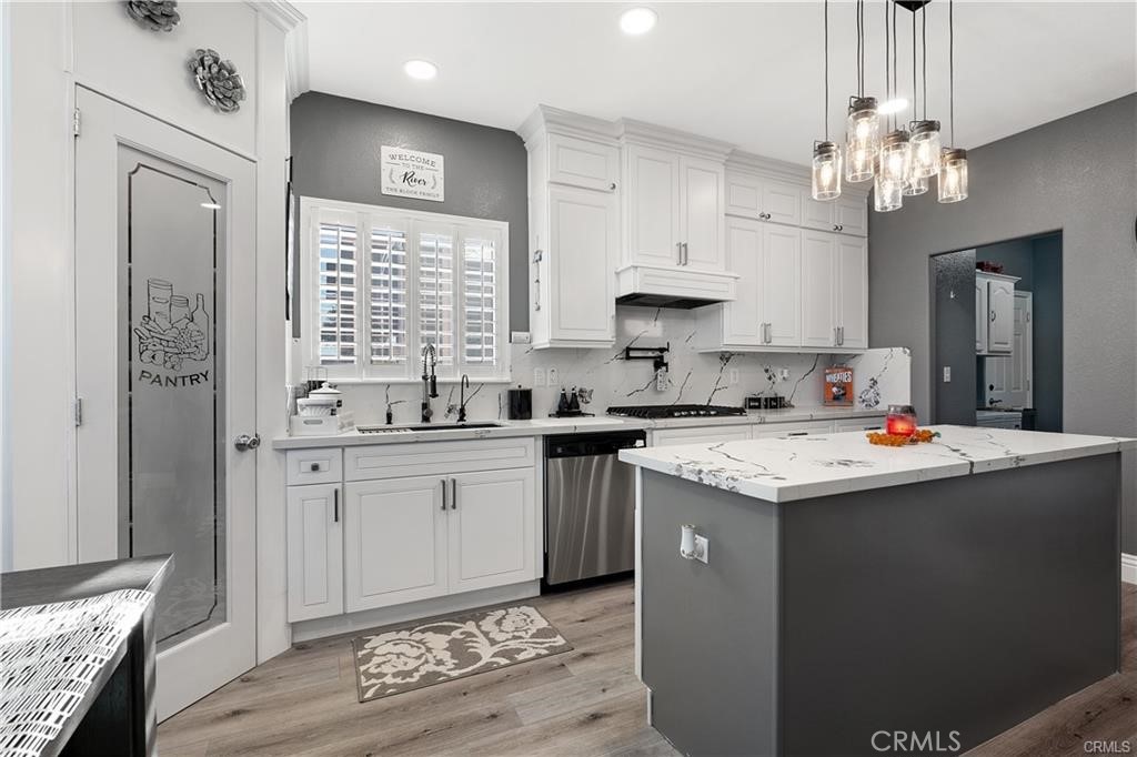 1188 Beach Drive Needles, CA 92363 - Photo 4 of 41 a kitchen with kitchen island granite countertop a sink stainless steel appliances and cabinets