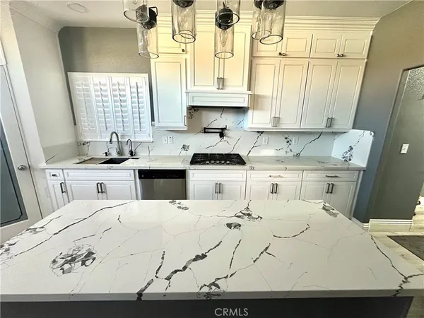a large white bed sitting in a bathroom next to a window
