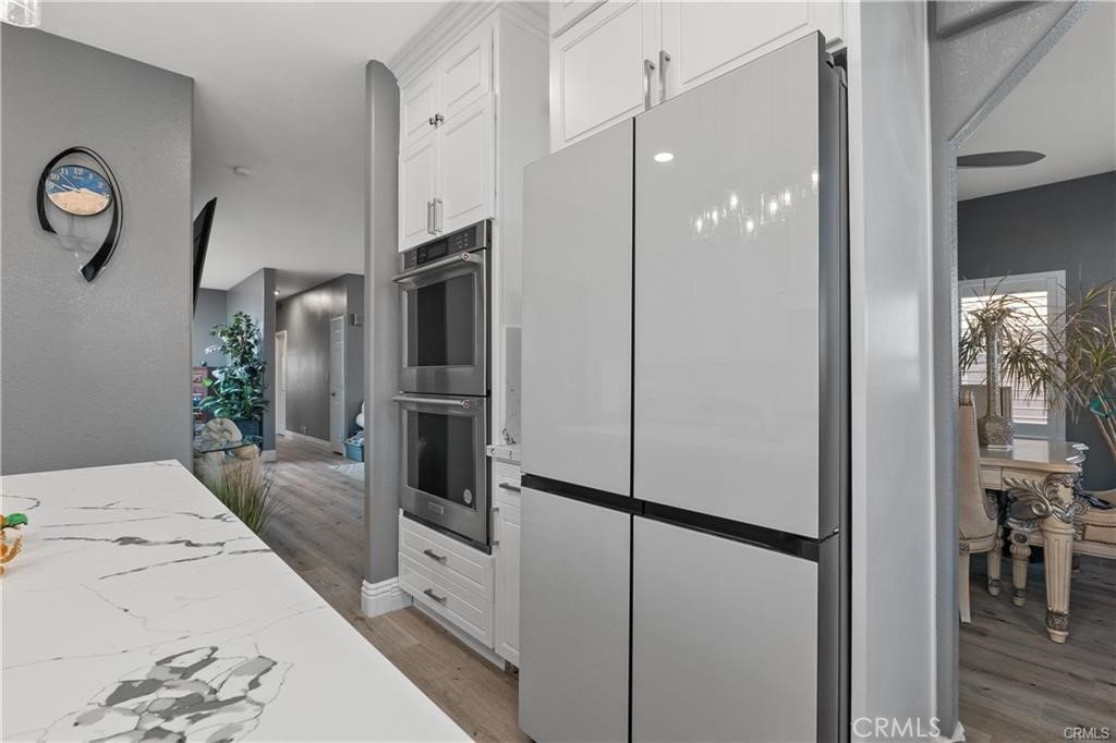 1188 Beach Drive Needles, CA 92363 - Photo 10 of 41 a kitchen with stainless steel appliances a refrigerator sink and cabinets