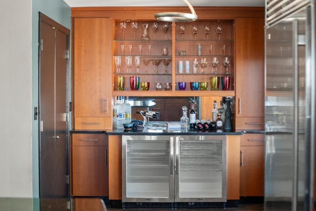 227 Summit Avenue, Unit E401 Brookline, MA 02446 - Photo 16 of 38 a kitchen with a refrigerator and cabinets