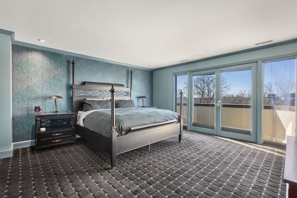 227 Summit Avenue, Unit E401 Brookline, MA 02446 - Photo 19 of 38 a bedroom with a bed and large window