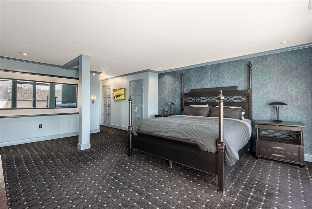 227 Summit Avenue, Unit E401 Brookline, MA 02446 - Photo 20 of 38 a bedroom with a bed and a window