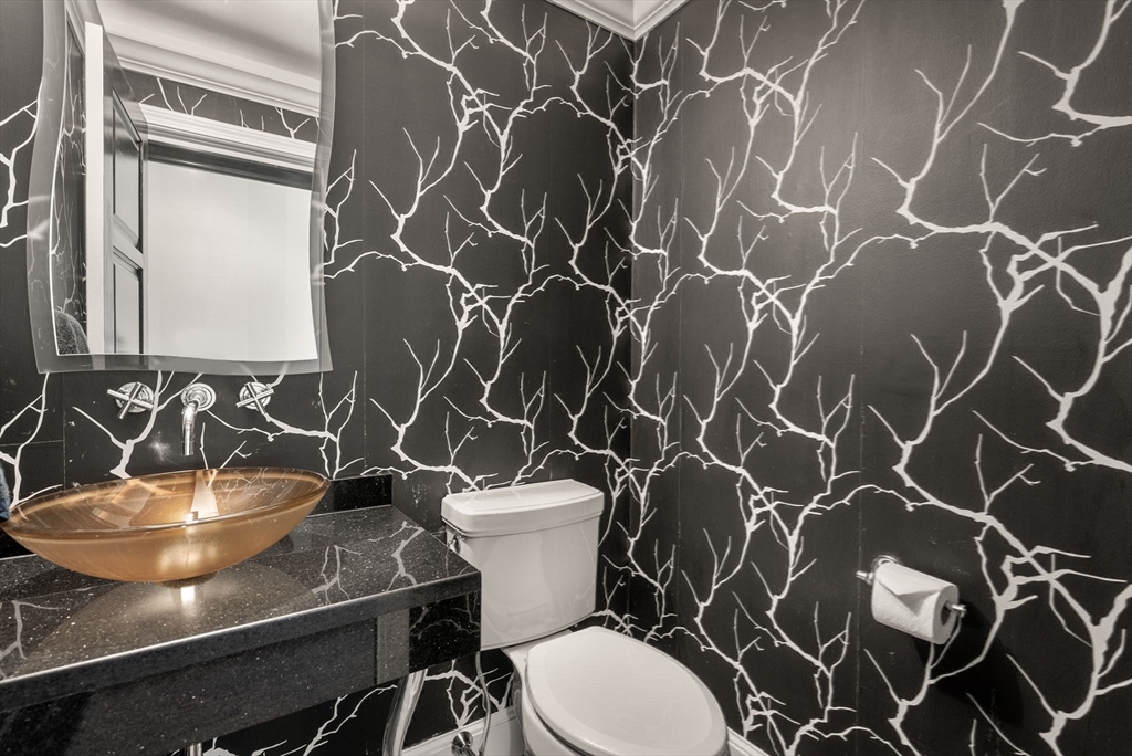 227 Summit Avenue, Unit E401 Brookline, MA 02446 - Photo 25 of 38 a bathroom with a sink and a mirror