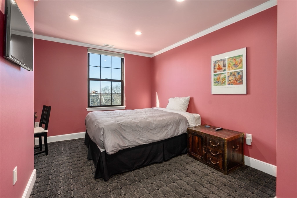 227 Summit Avenue, Unit E401 Brookline, MA 02446 - Photo 26 of 38 a bed room with a bed and a tv