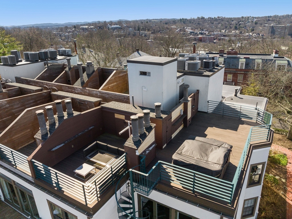 227 Summit Avenue, Unit E401 Brookline, MA 02446 - Photo 33 of 38 a view of a patio with a table chairs and iron fence