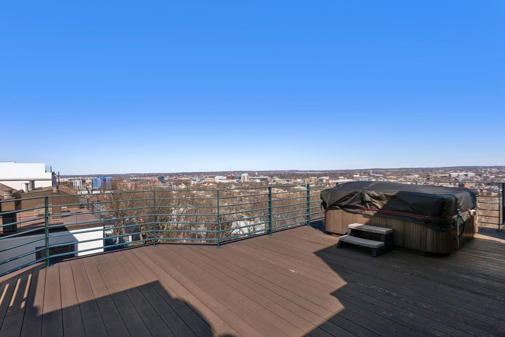 227 Summit Avenue, Unit E401 Brookline, MA 02446 - Photo 37 of 38 a view of a balcony with wooden floor