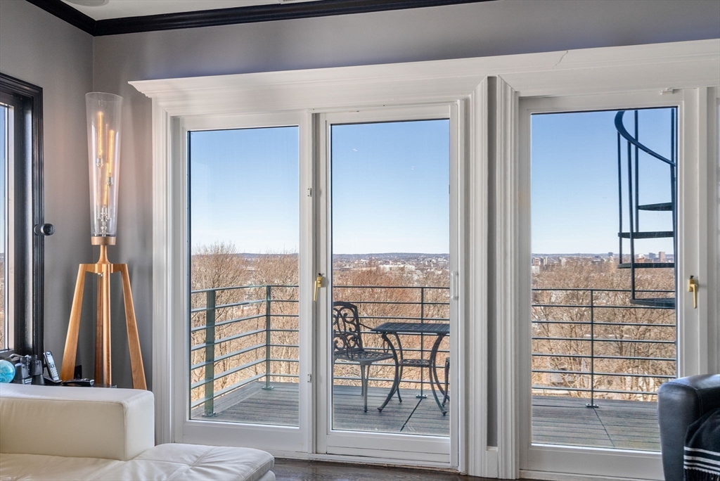 227 Summit Avenue, Unit E401 Brookline, MA 02446 - Photo 4 of 38 a view of a living room and a balcony
