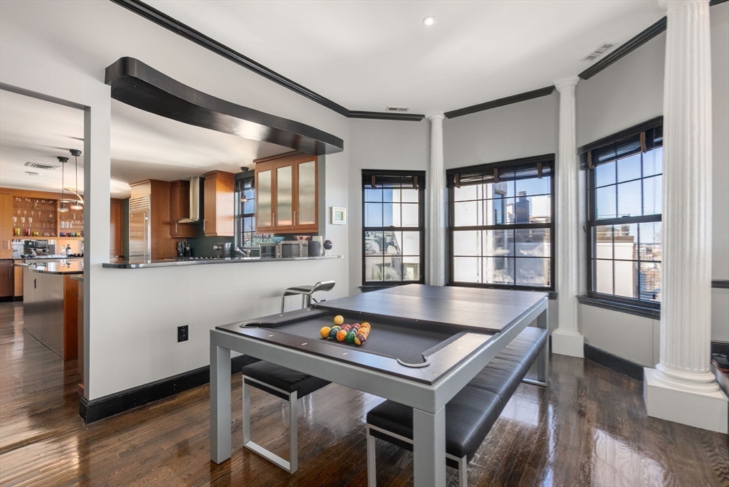 227 Summit Avenue, Unit E401 Brookline, MA 02446 - Photo 8 of 38 a living room with stainless steel appliances kitchen island granite countertop lots of wooden furniture and large windows