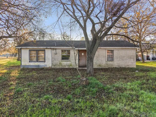 a house that has a tree in front of a house