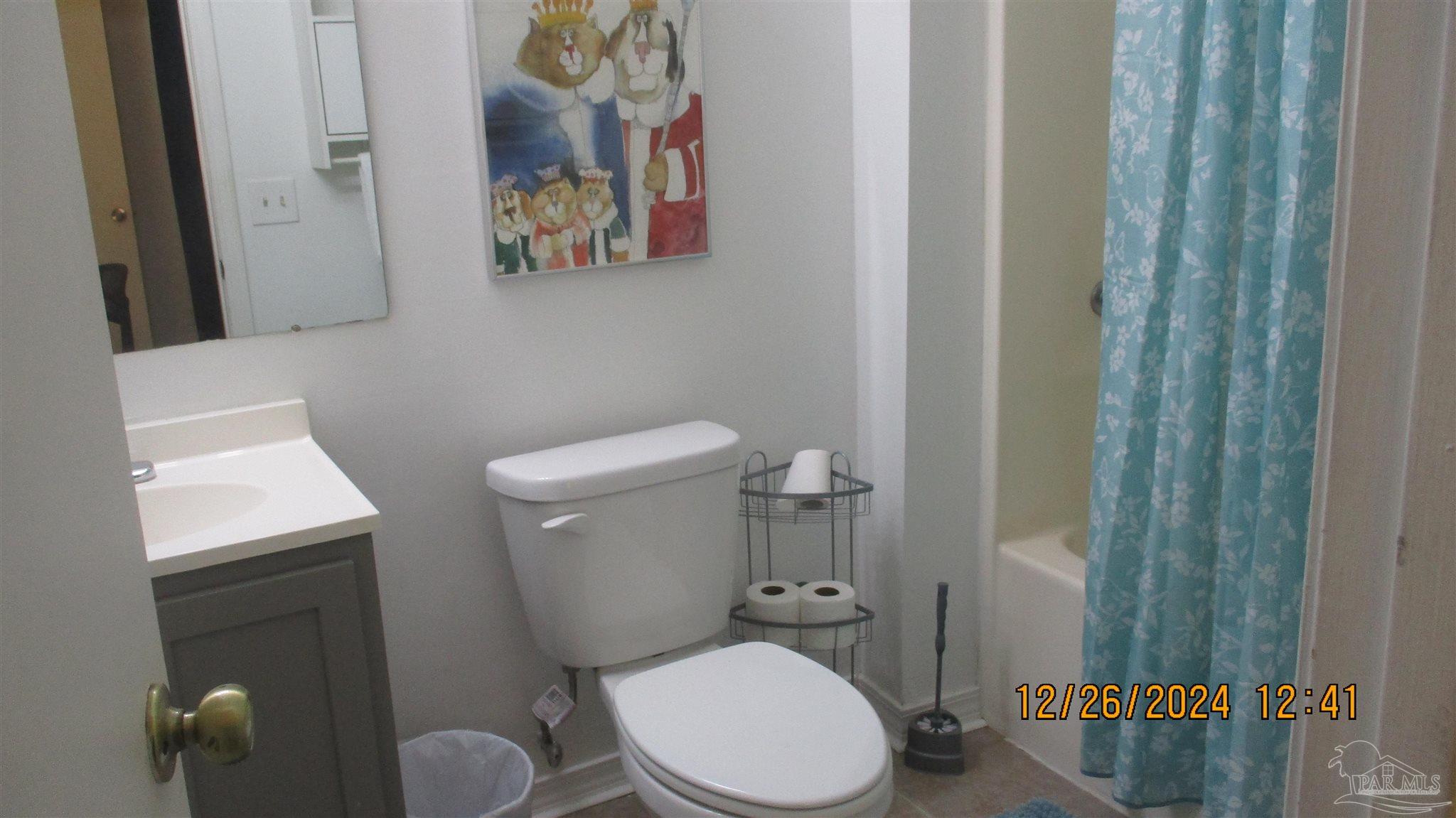 501 East Burgess Road, Unit C1 Pensacola, FL 32504 - Photo 13 of 16 a white toilet sitting next to a bathroom sink