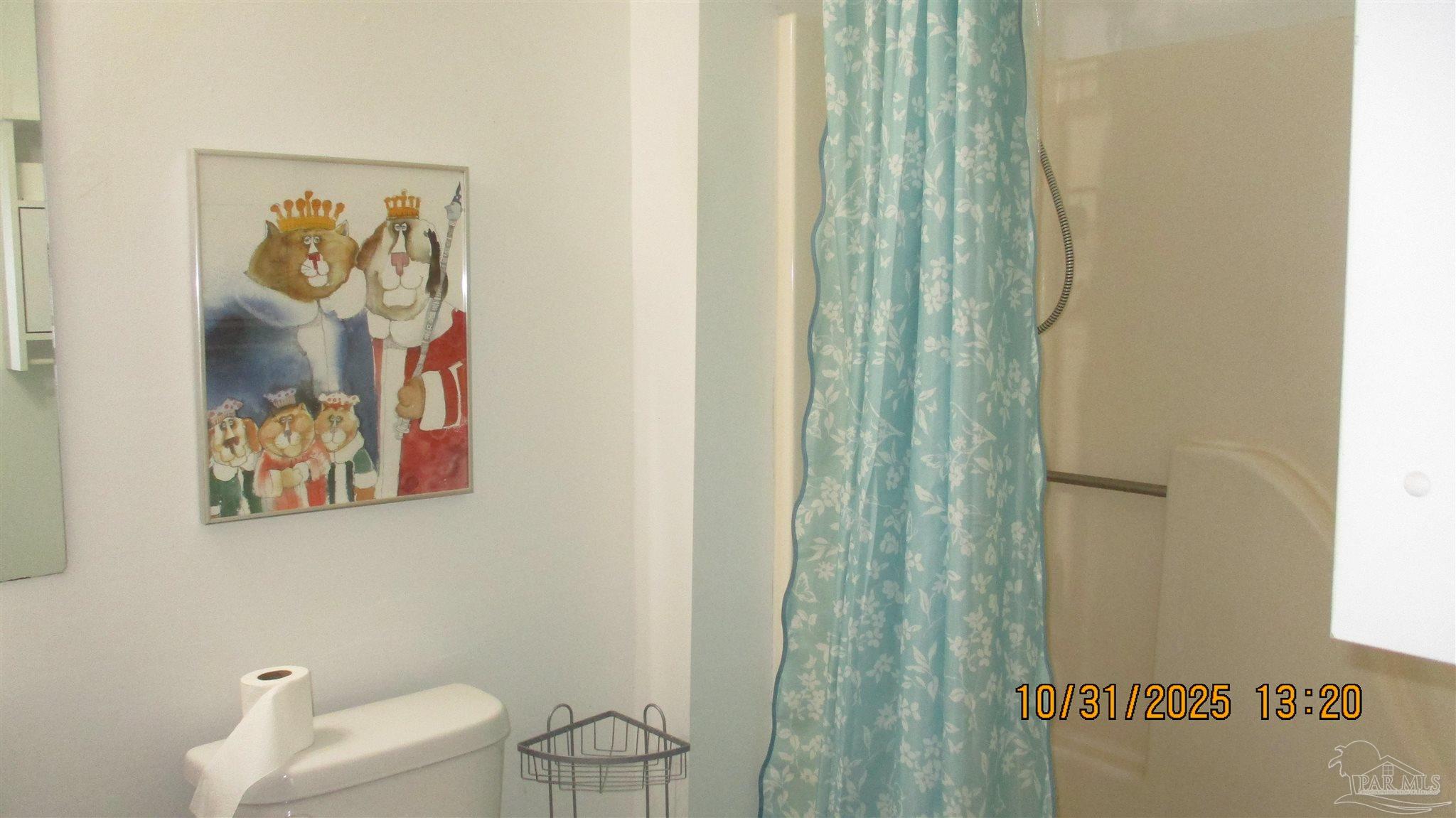 501 East Burgess Road, Unit C1 Pensacola, FL 32504 - Photo 14 of 16 a bathroom with a toilet and a shower curtain