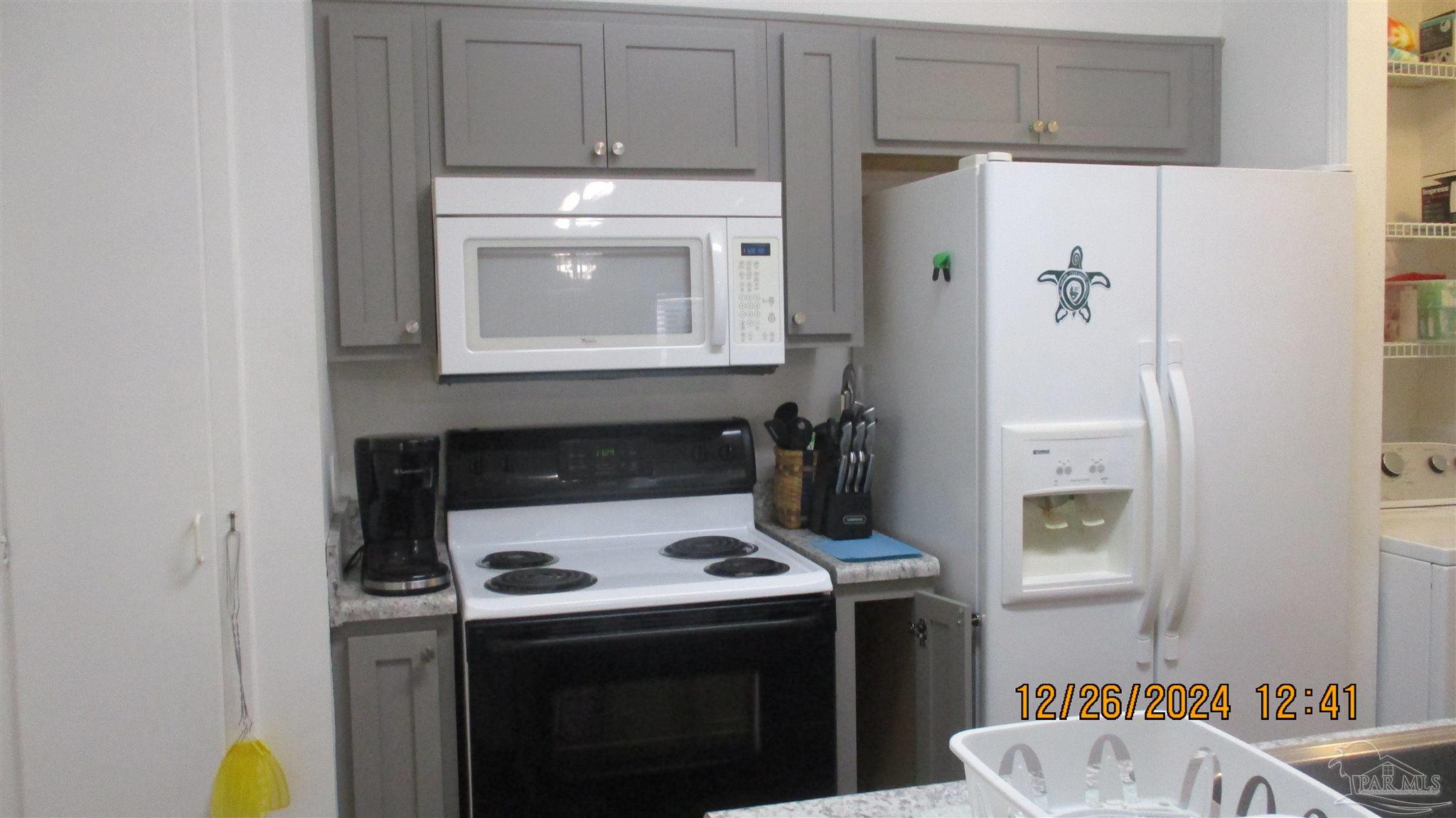 501 East Burgess Road, Unit C1 Pensacola, FL 32504 - Photo 7 of 16 a kitchen with a stove and a refrigerator