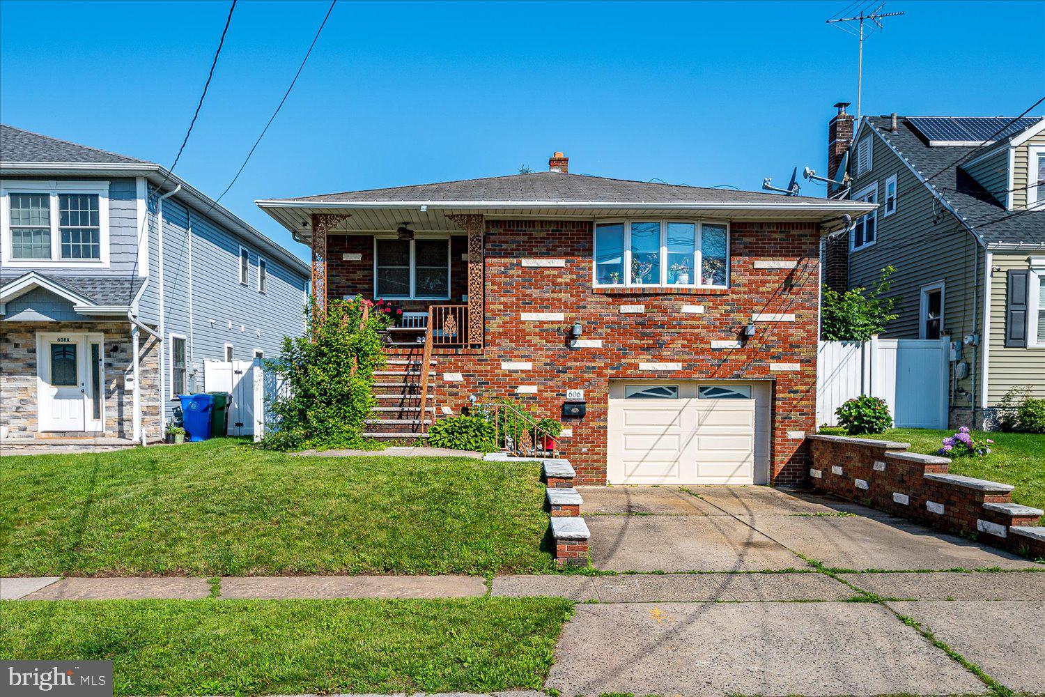 606 Knopf Street Linden, NJ 07036 - Photo 1 of 34 a front view of a house with a garden