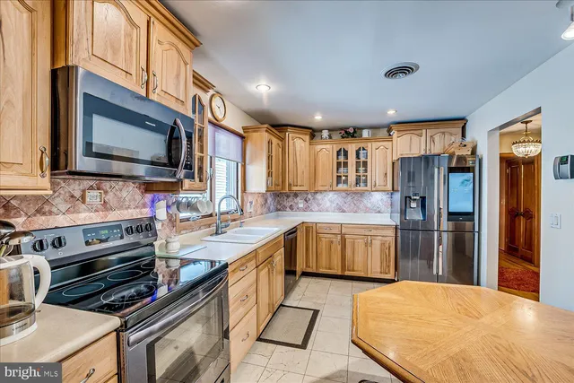 a kitchen with a sink stove and refrigerator