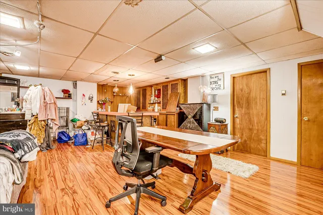a view of a backyard with chair and potted plants