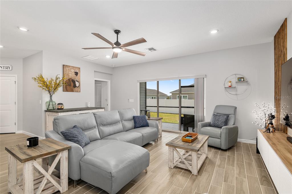 5688 Southwest 92nd Place Ocala, FL 34476 - Photo 11 of 54 a living room with furniture and a wooden floor