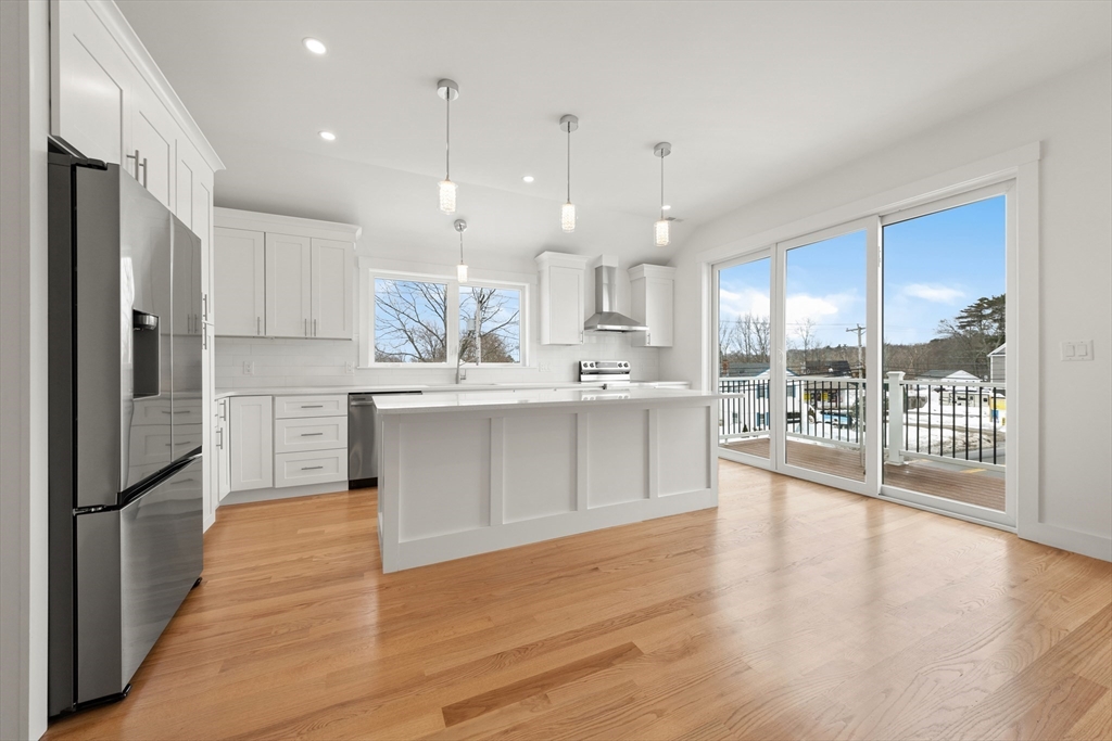 2 Old County Road, Unit 10 Salisbury, MA 01952 - Photo 3 of 27 a large kitchen with stainless steel appliances kitchen island granite countertop a large cabinets a sink and stainless steel appliances