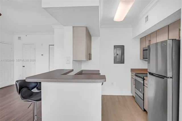 a kitchen with a sink refrigerator and microwave