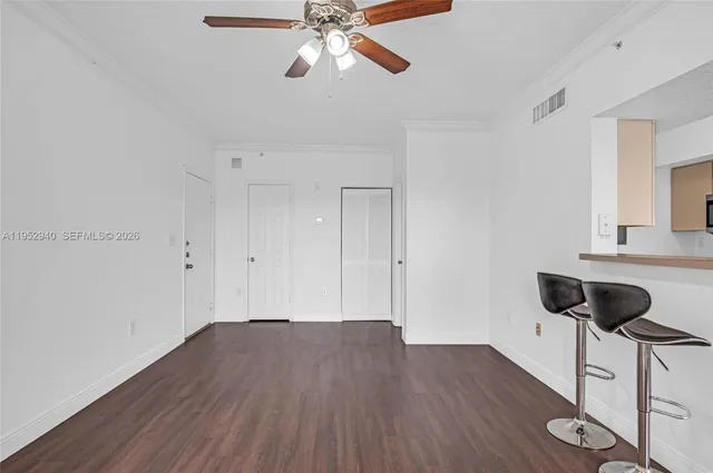 a view of a room with wooden floor and windows