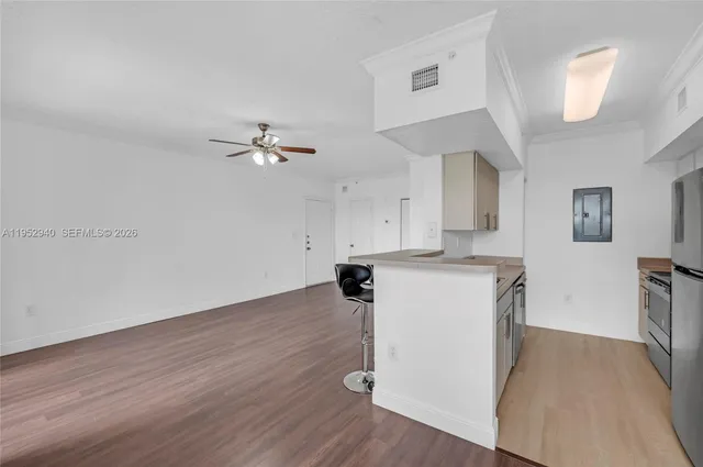 a view of a kitchen with sink and wooden floor