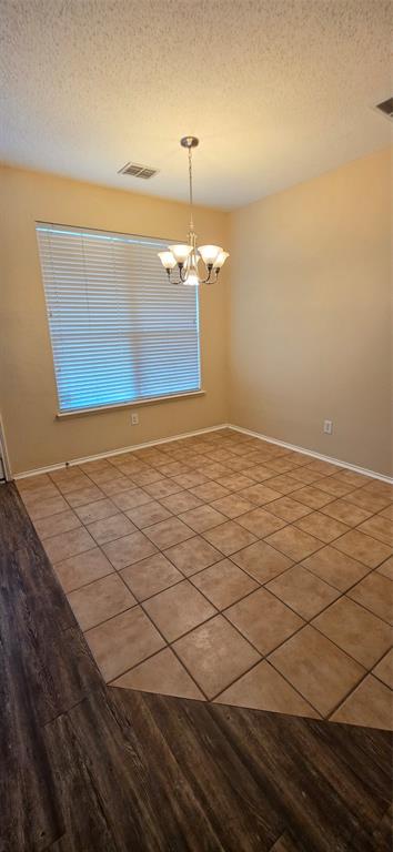 2820 Deer Ridge Drive Rockwall, TX 75032 - Photo 12 of 36 Tile flooring, wood-finish flooring, single window with blinds, overhead chandelier