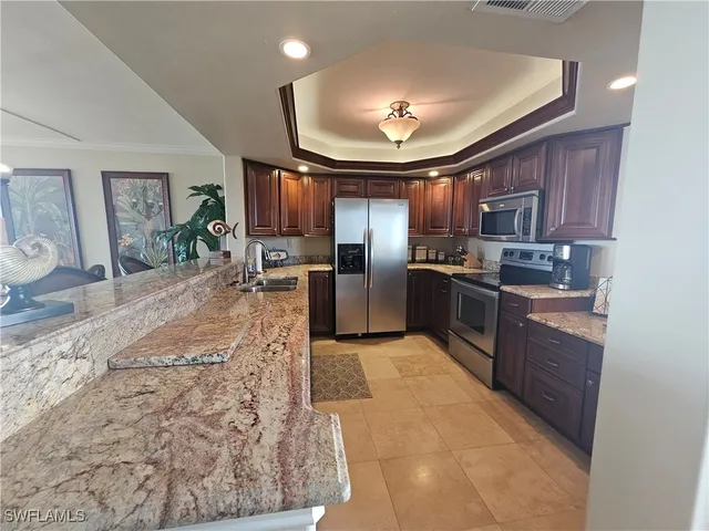 a large kitchen with cabinets and stainless steel appliances