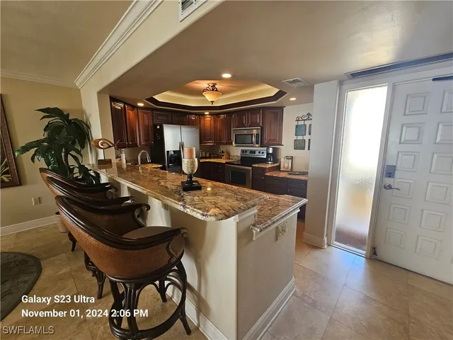 a kitchen with stainless steel appliances a sink a stove and a refrigerator