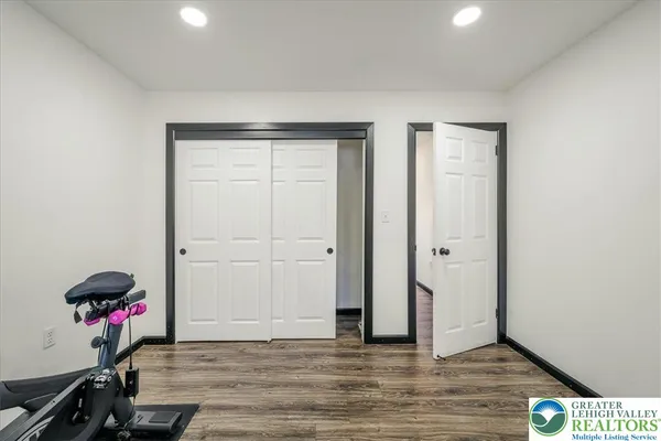 a view of a room with wooden floor